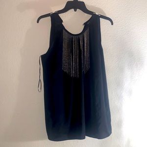Beautiful Jennifer lopes black top with silver accent. Back button closure.